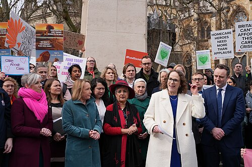 Alison Bennett MP speaking to campaigners outside parliament who are protesting for carers