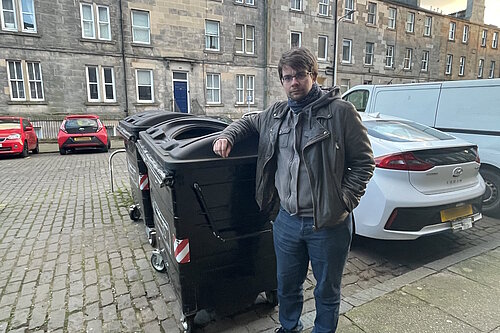 Cllr Jack Caldwell standing next to a broken bin on Pitt Street