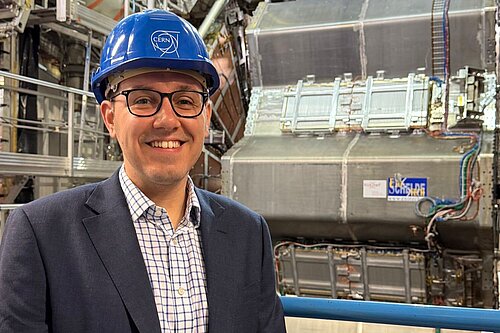 Tom Gordon stood in front of machinery at CERN