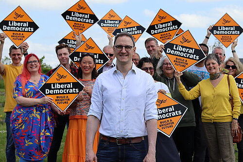 Ian Sollom with volunteers in the background