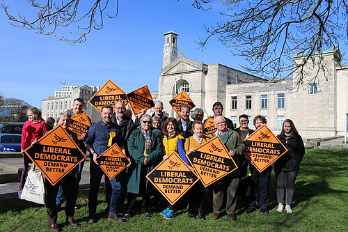 A gathering of Liberal Democrat Supporters holding signs in front of Southampton's Civic centre