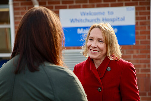 Helen speaking to a resident outside a Shropshire hospital