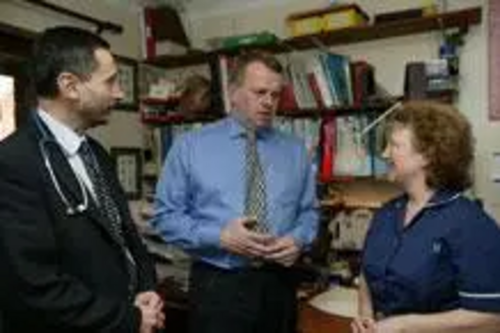 Peter Carroll talking with a local Doctor and Nurse