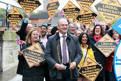 Ed Davey in front of crowd with Lib Dem diamond signs