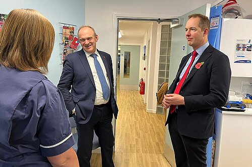 Richard Foord and Ed Davey talking to staff at a GP surgery