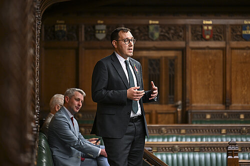 Tom Gordon stood speaking in the House of Commons Chamber