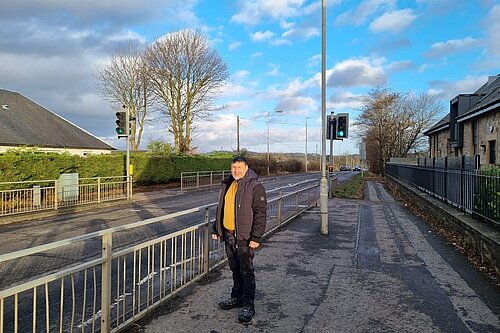 Marthos Christoforou standing by a light controlled road crossing.