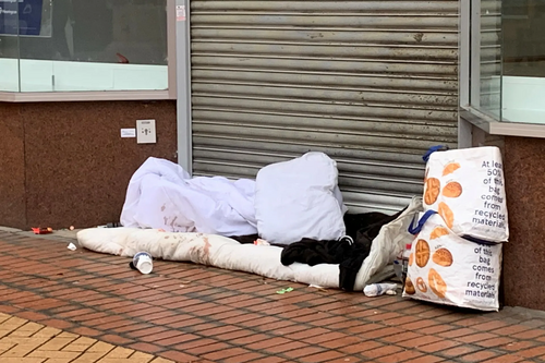 homeless belongings in doorway