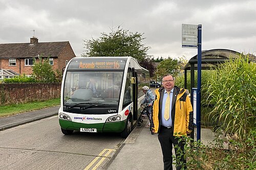 Andrew Waller standing at the bus stop as passengers board a number 16 bus