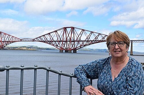 Christine Jardine standing in the foreground with the Forth Bridges in the background