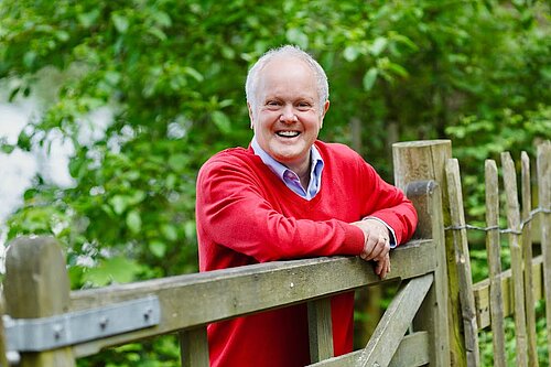 Clive Jones outside leaning on a wooden gate