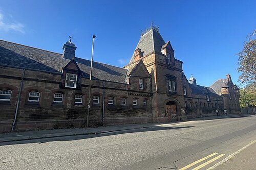 Powderhall Stables with a blue sky in the background