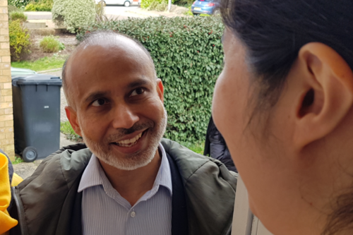 Sarwar Shashmer speaking to a resident 