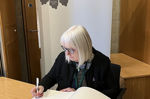 Beatrice Wishart signing The Book of Commitment organised by the Holocaust Education Trust.