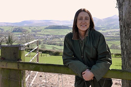 Jane Dodds MS standing in front of Green hills in Mid Wales