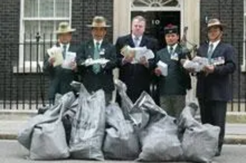 Peter Carroll handing petitions in to 10 Downing Street with retired Gurkhas