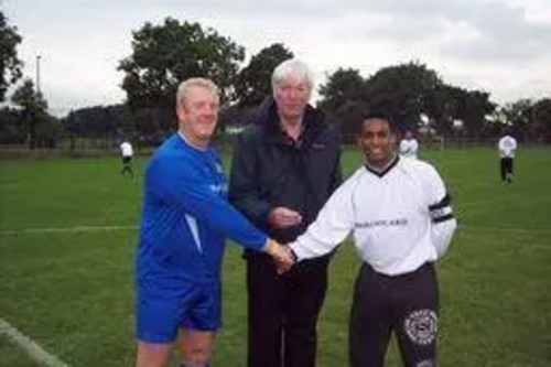 Starting the unique match - Paul Rowen MP tosses the coin with the team captains.