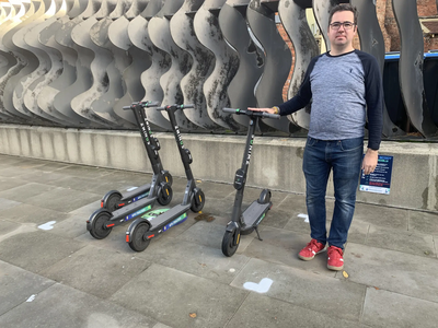 Councillor Sebastian Field with e-scooters