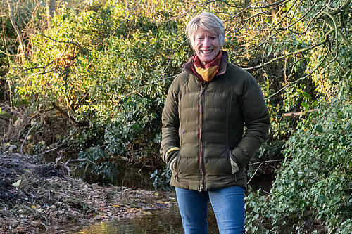 Pippa Heylings stand next to a typical South Cambridgeshire stream