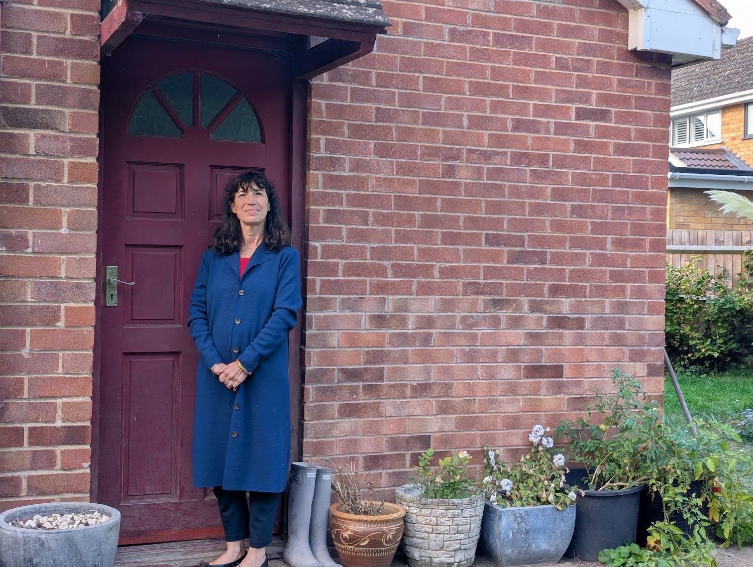 Manuela outside of a house